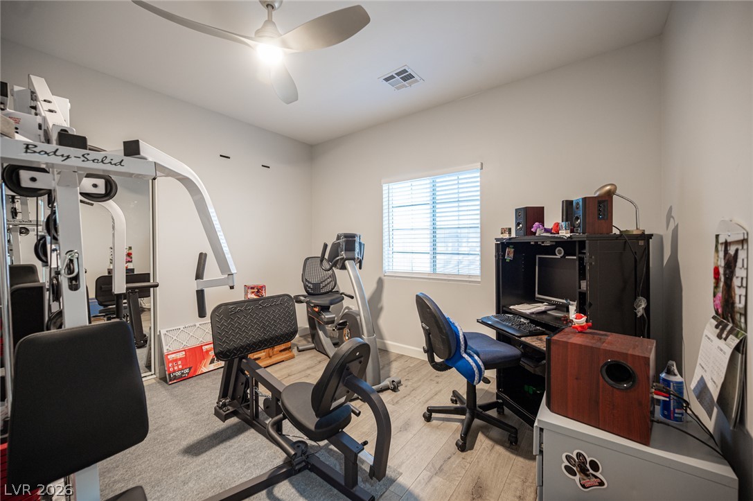 441 Belville Road Pahrump, NV 89048 - Photo 24 of 44 Fitness and work converge in this versatile space, featuring sleek flooring and essential amenities.
