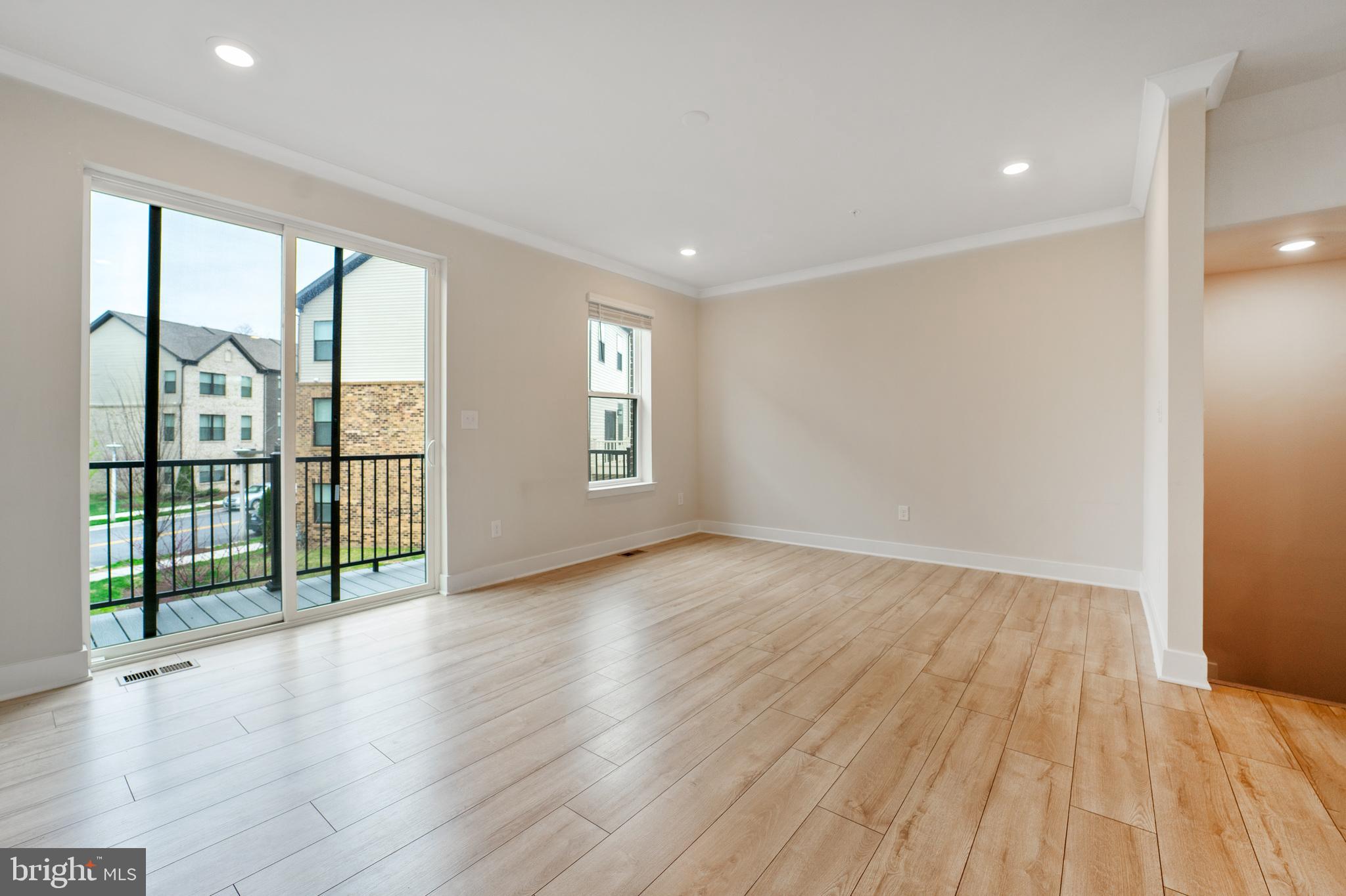 4334 Roland Heights Avenue Baltimore, MD 21211 - Photo 14 of 32 wooden floor in an empty room with a window