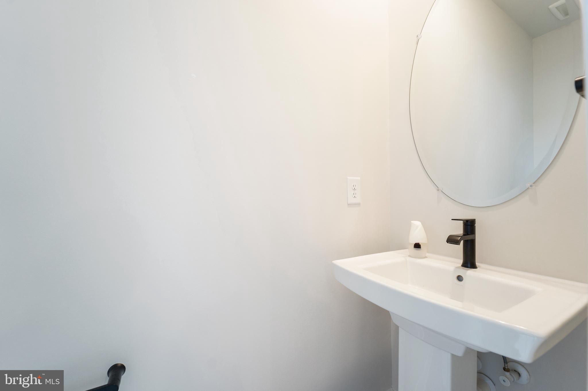 4334 Roland Heights Avenue Baltimore, MD 21211 - Photo 15 of 32 a bathroom with a sink and a mirror