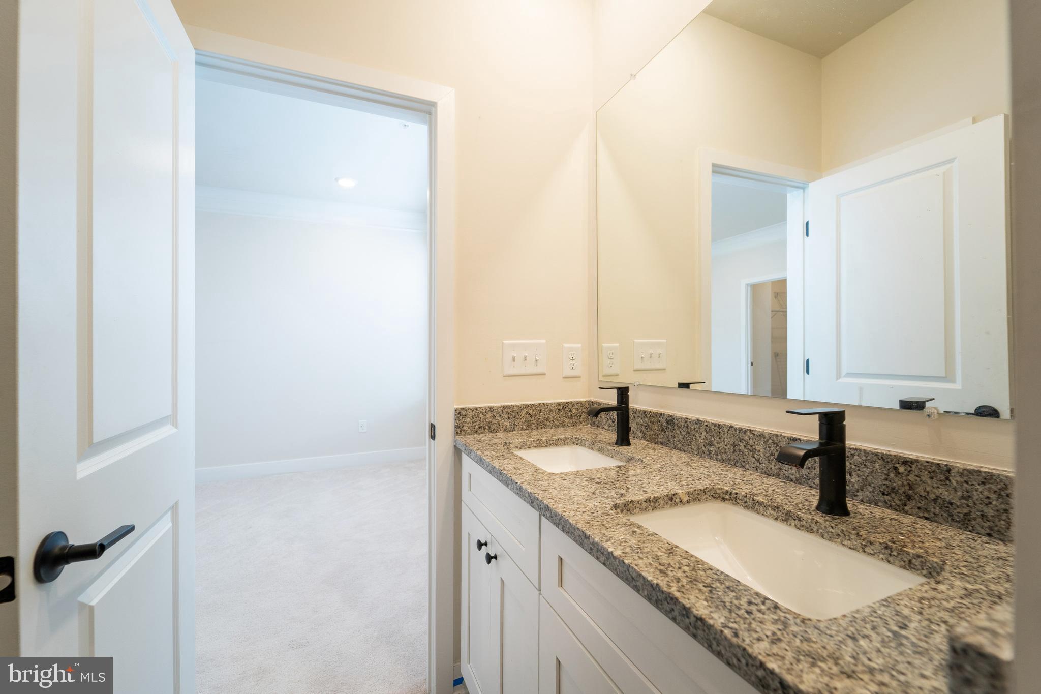 4334 Roland Heights Avenue Baltimore, MD 21211 - Photo 21 of 32 a bathroom with a granite countertop sink and a mirror