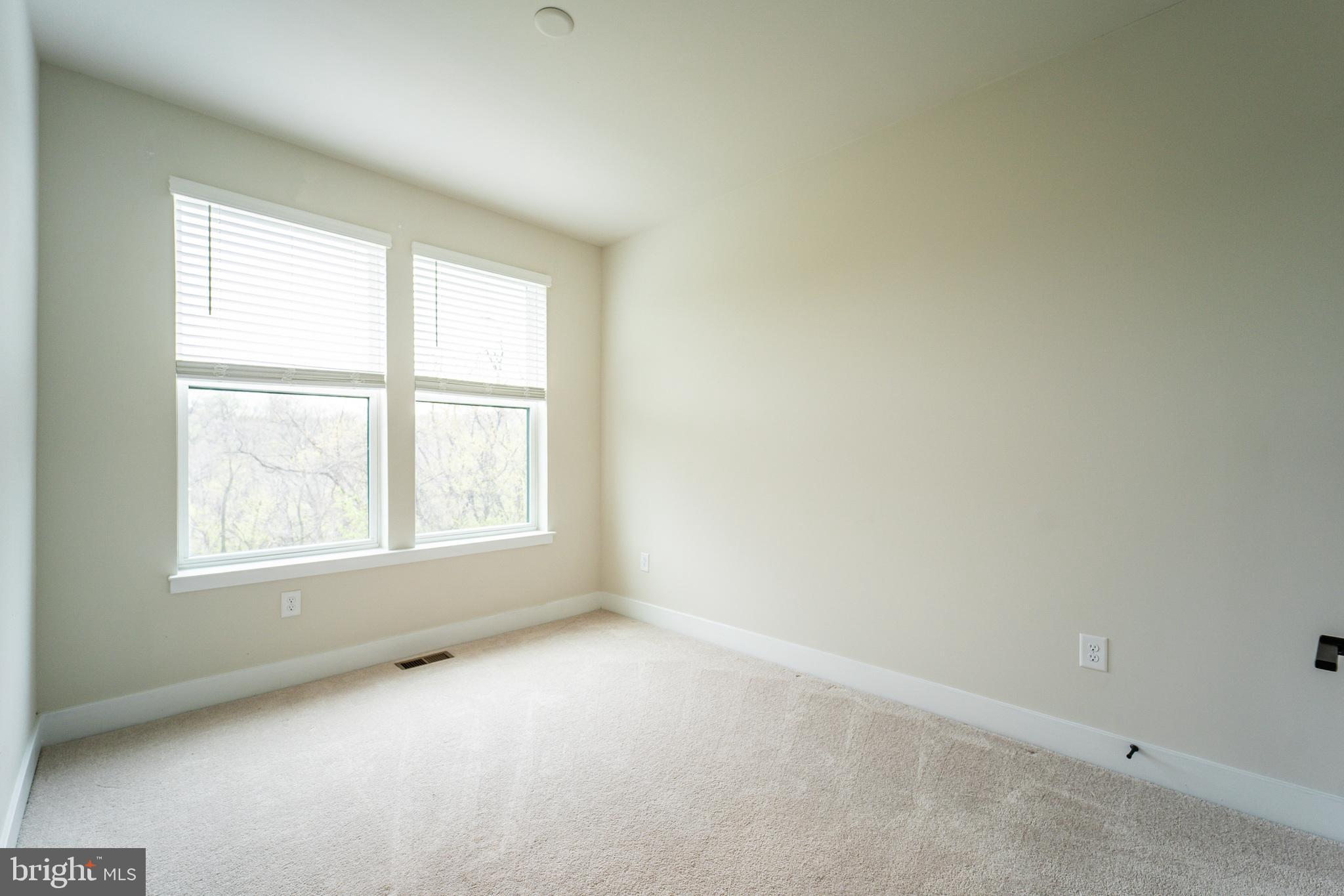 4334 Roland Heights Avenue Baltimore, MD 21211 - Photo 23 of 32 an empty room with a window