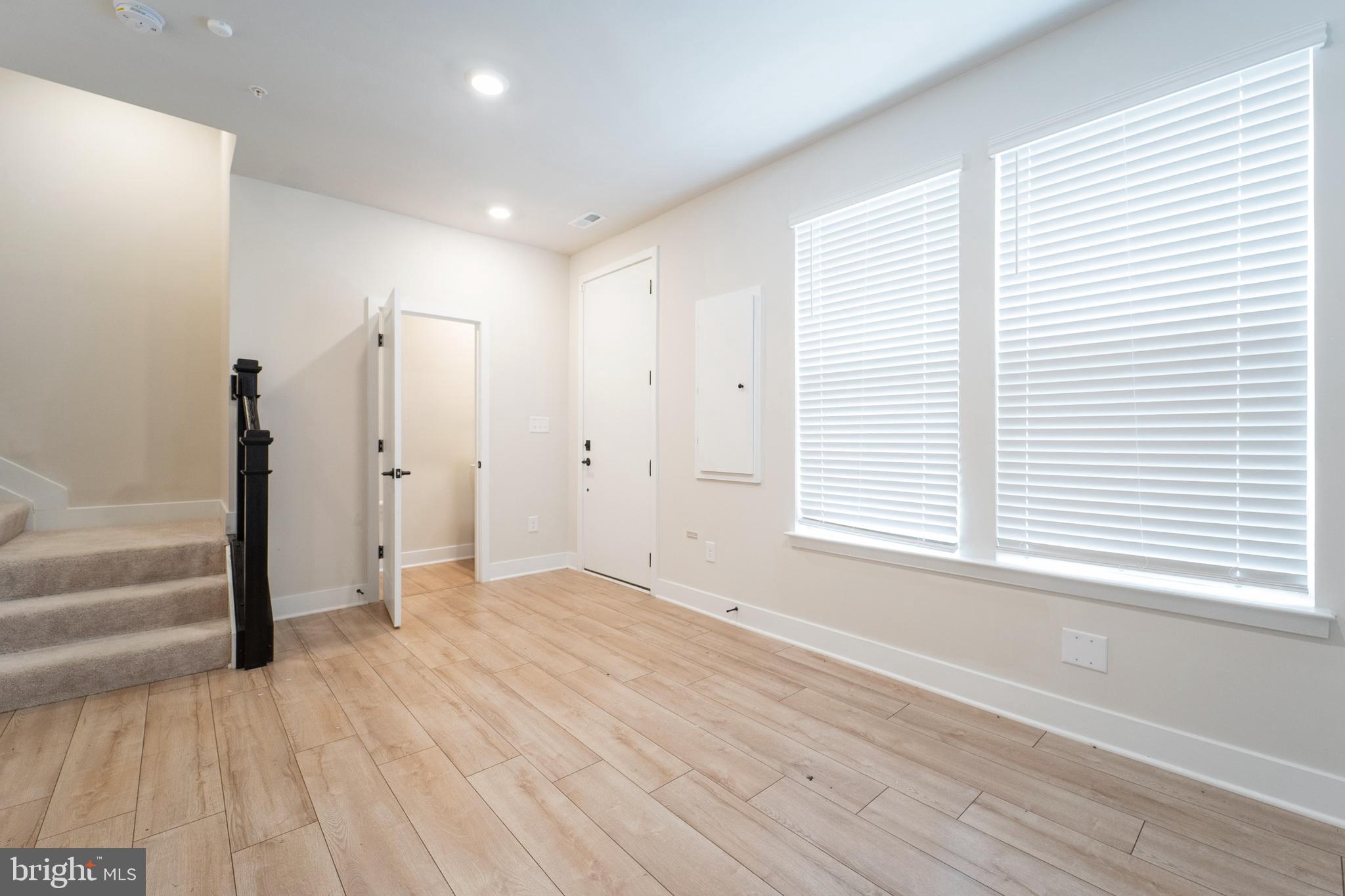 4334 Roland Heights Avenue Baltimore, MD 21211 - Photo 30 of 32 a view of an empty room with wooden floor and a window
