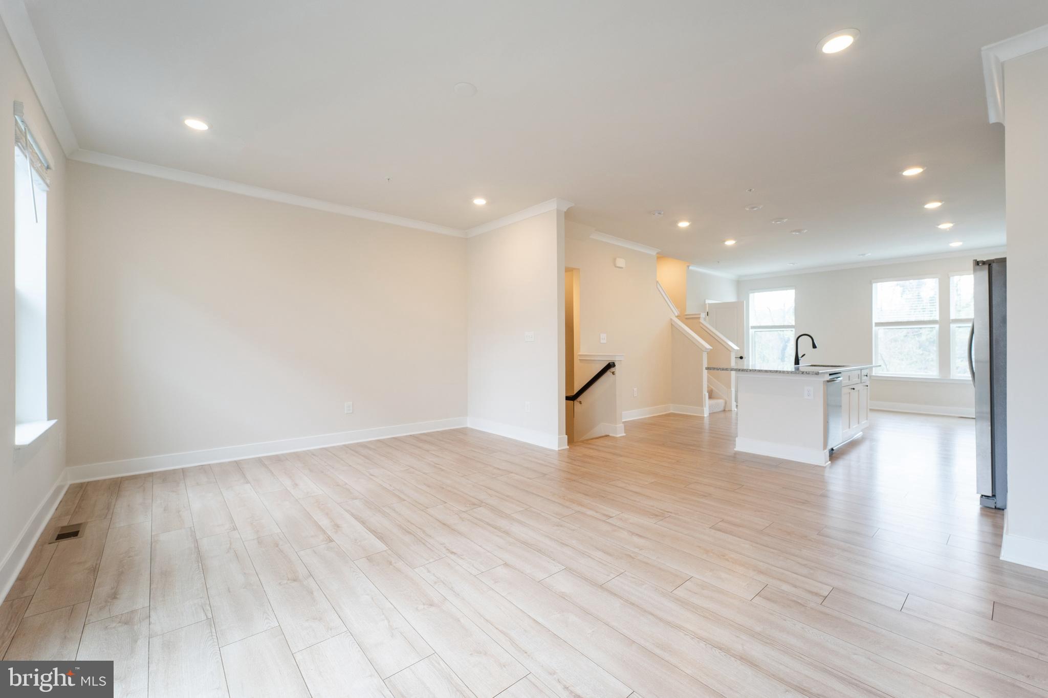 4334 Roland Heights Avenue Baltimore, MD 21211 - Photo 3 of 32 a view of an empty room with wooden floor and a window