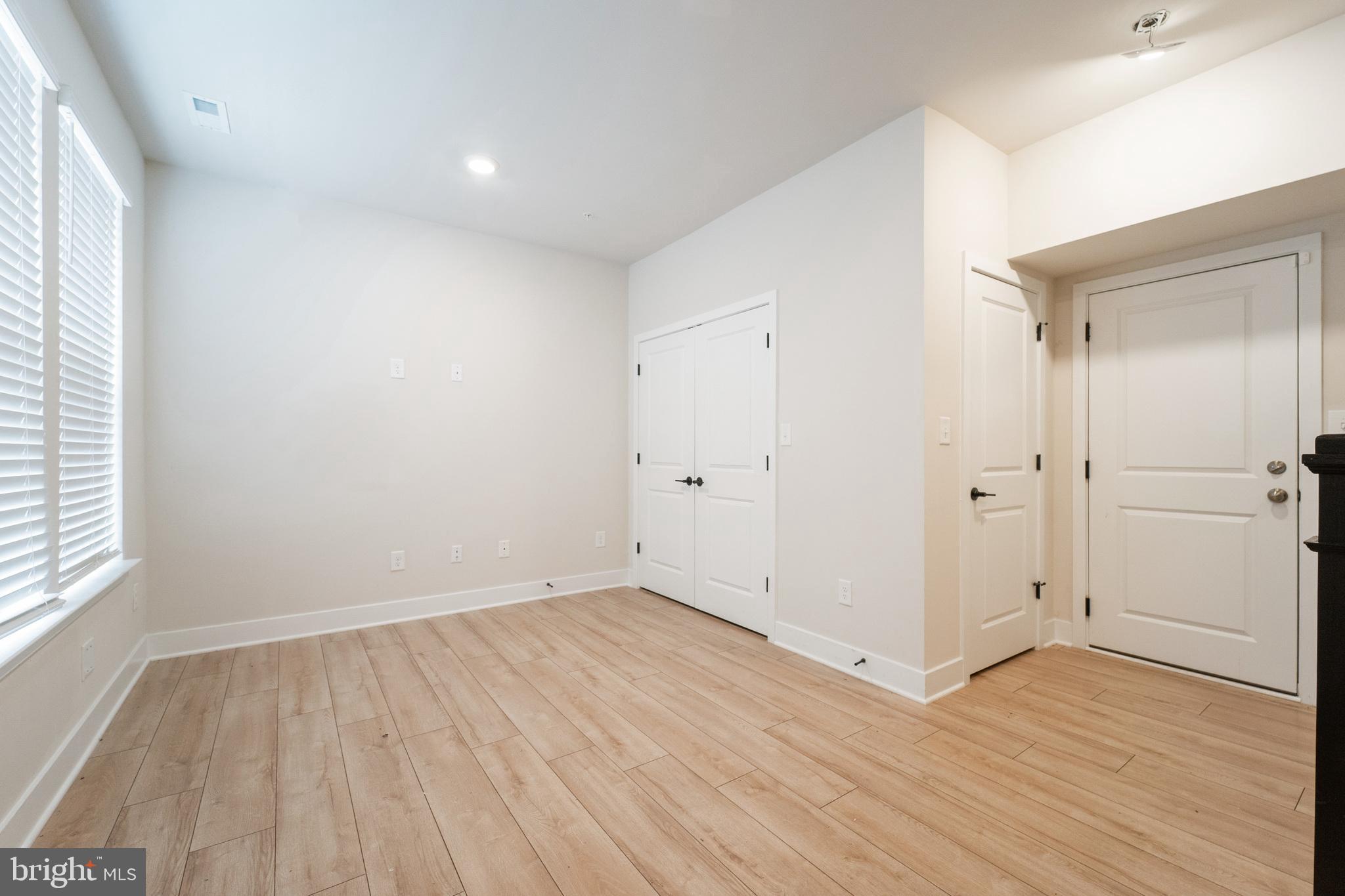 4334 Roland Heights Avenue Baltimore, MD 21211 - Photo 31 of 32 an empty room with wooden floor