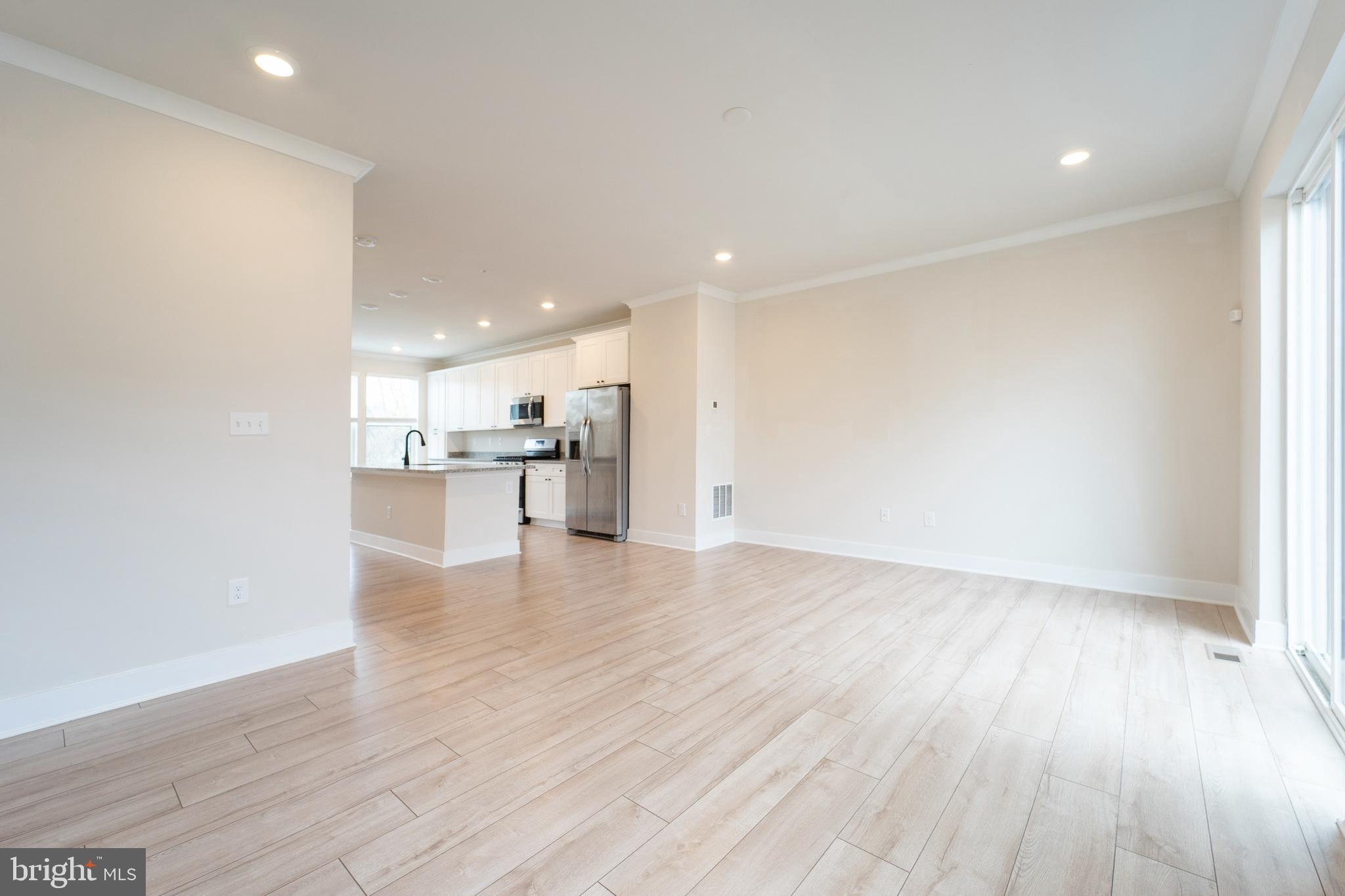 4334 Roland Heights Avenue Baltimore, MD 21211 - Photo 4 of 32 a view of a kitchen with a sink and wooden floor