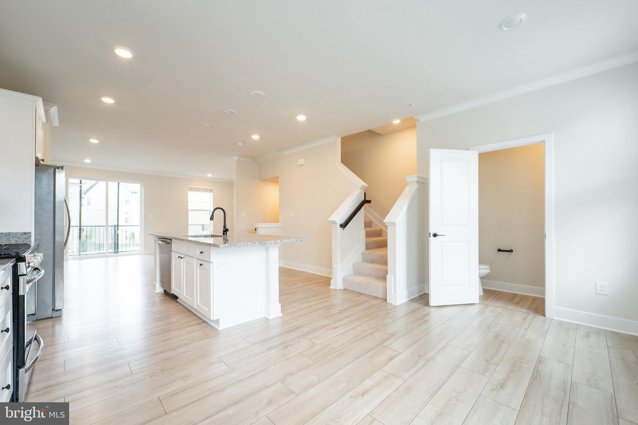 4334 Roland Heights Avenue Baltimore, MD 21211 - Photo 7 of 32 a view of a kitchen with wooden floor and a living room