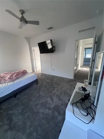 a bed room with a bed and a tv