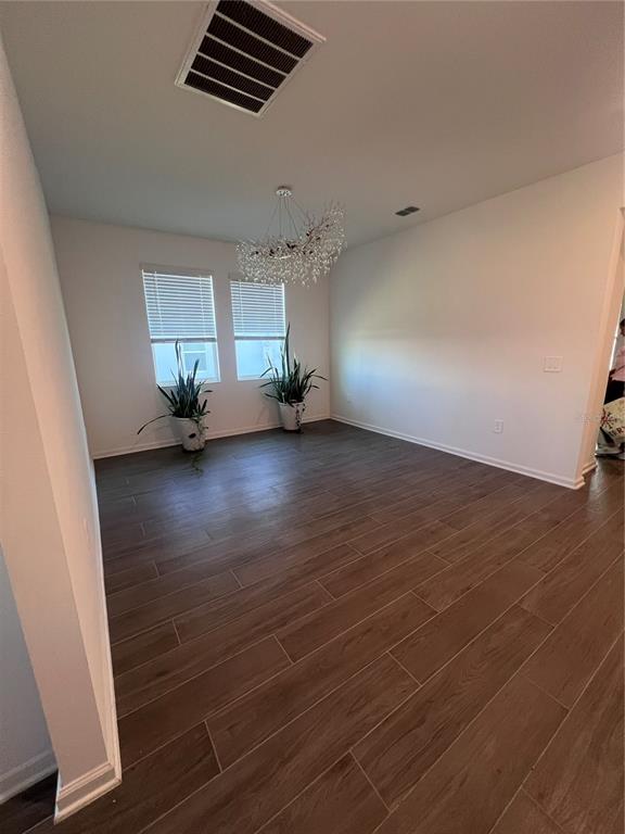 2653 Runners Circle Clermont, FL 34714 - Photo 12 of 13 an empty room with wooden floor and windows