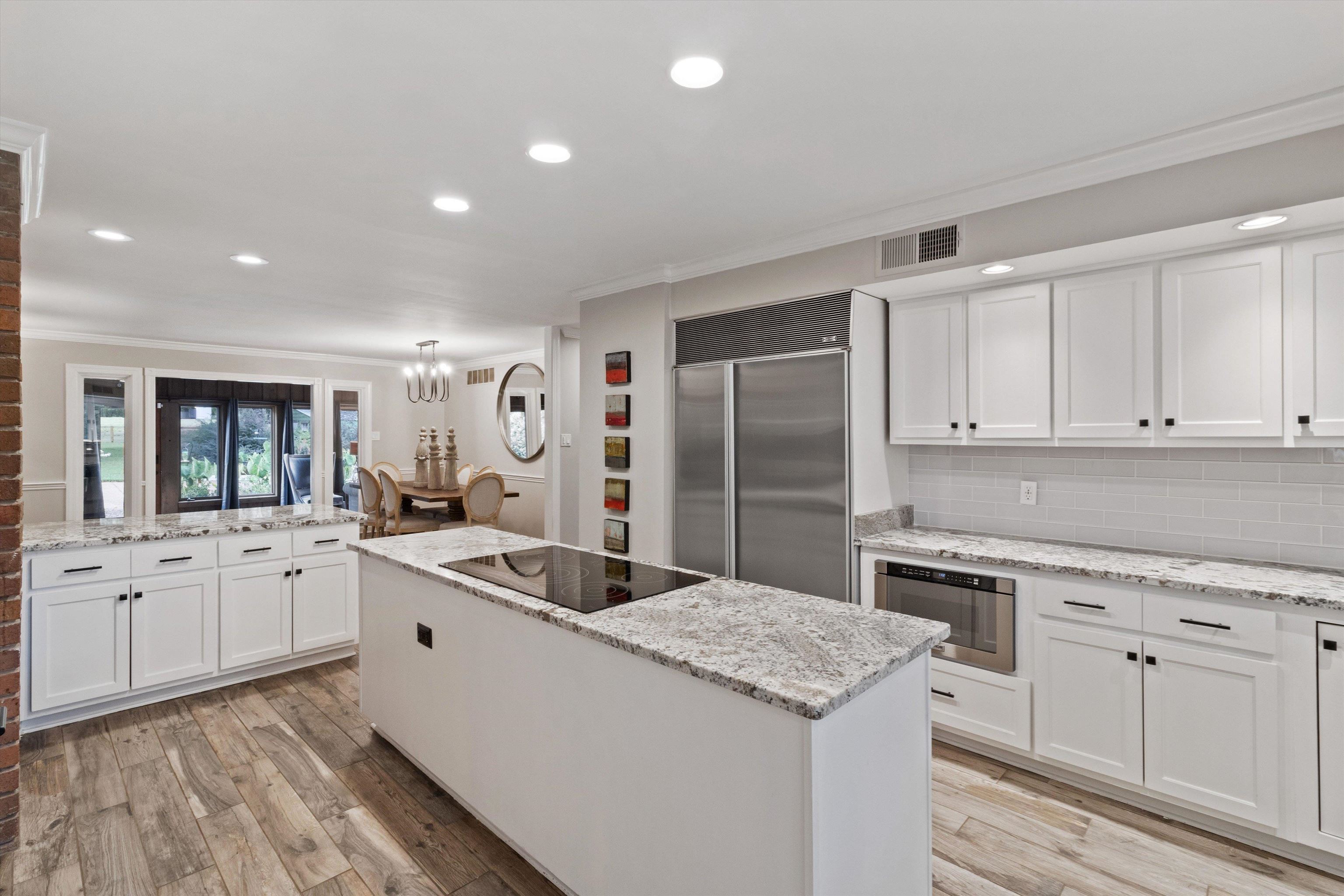 2345 North Reid Hooker Road Eads, TN 38028 - Photo 10 of 40 Kitchen with white cabinets, ornamental molding, a center island, backsplash, and recessed lighting