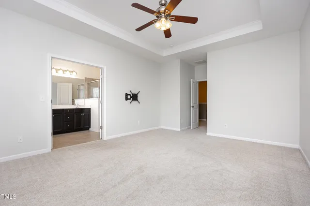 a view of an empty room with a ceiling fan