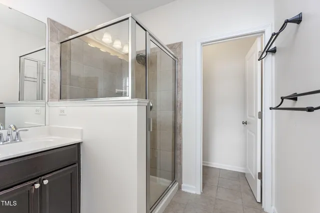 a bathroom with a shower sink and mirror