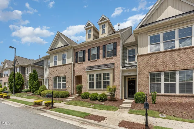 a view of a brick building next to a yard