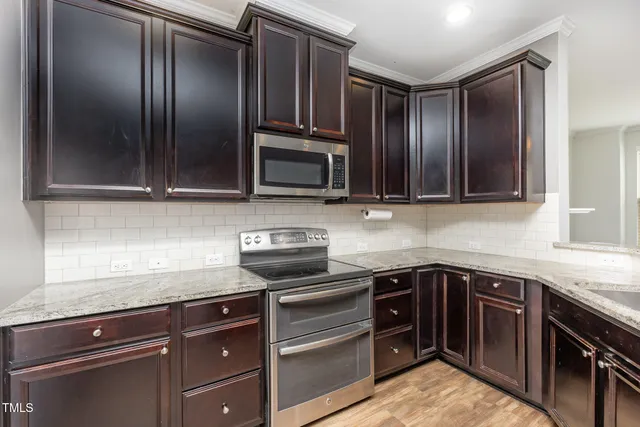 a kitchen with granite countertop stainless steel appliances and cabinets