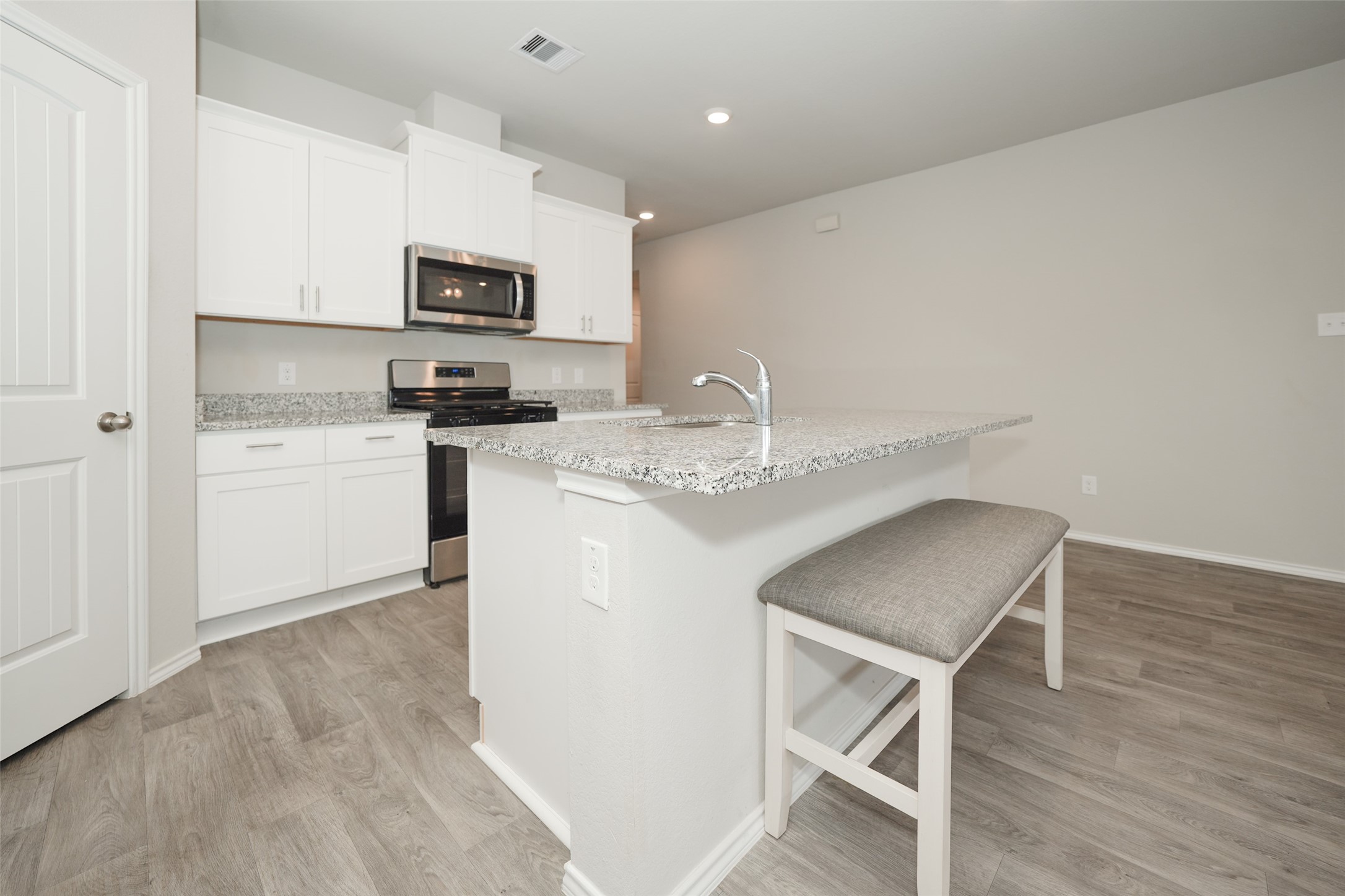 2407 Divot Lane Navasota, TX 77868 - Photo 16 of 37 a kitchen with stainless steel appliances granite countertop a microwave sink and refrigerator