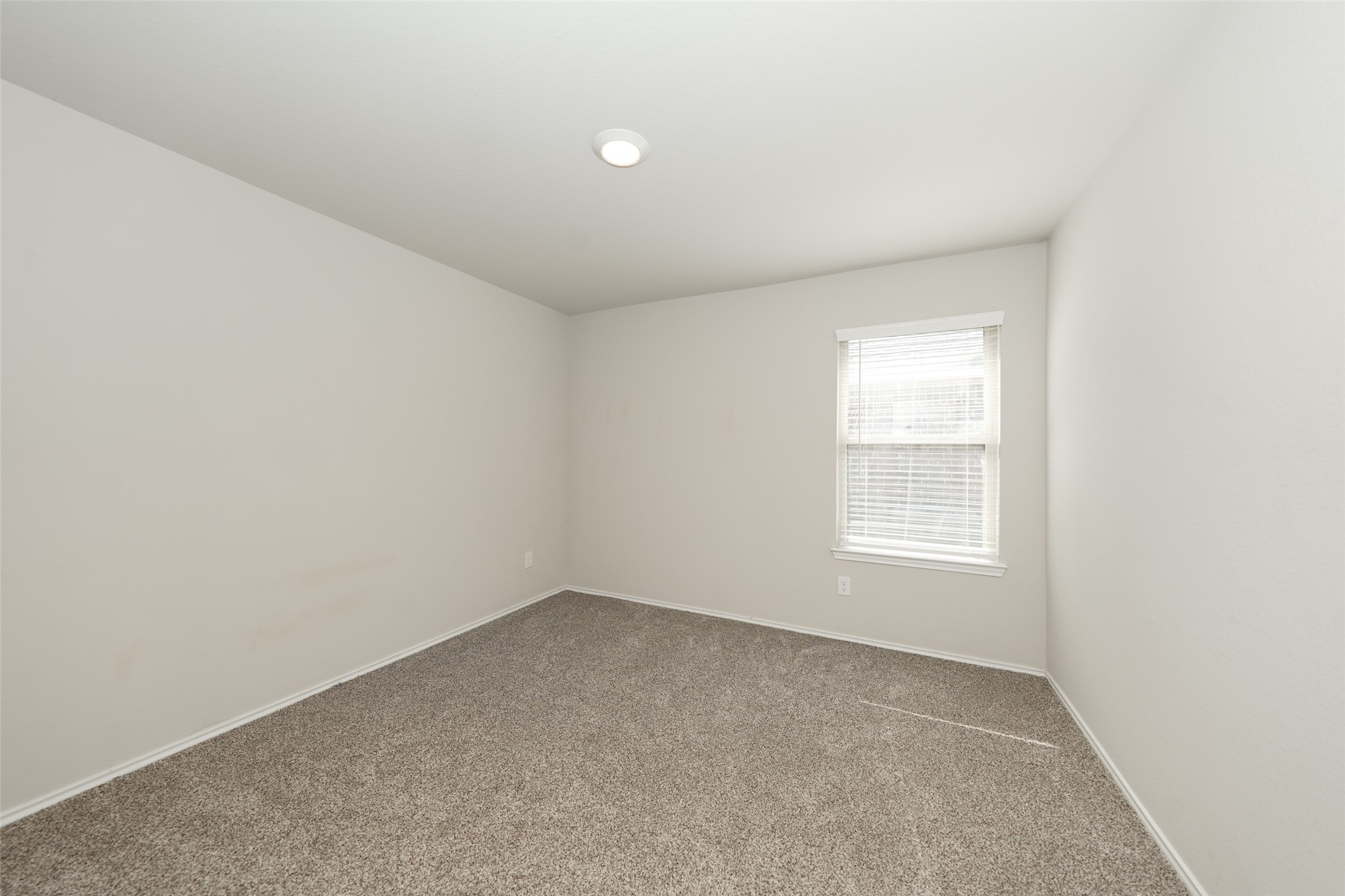 2407 Divot Lane Navasota, TX 77868 - Photo 3 of 37 an empty room with a window