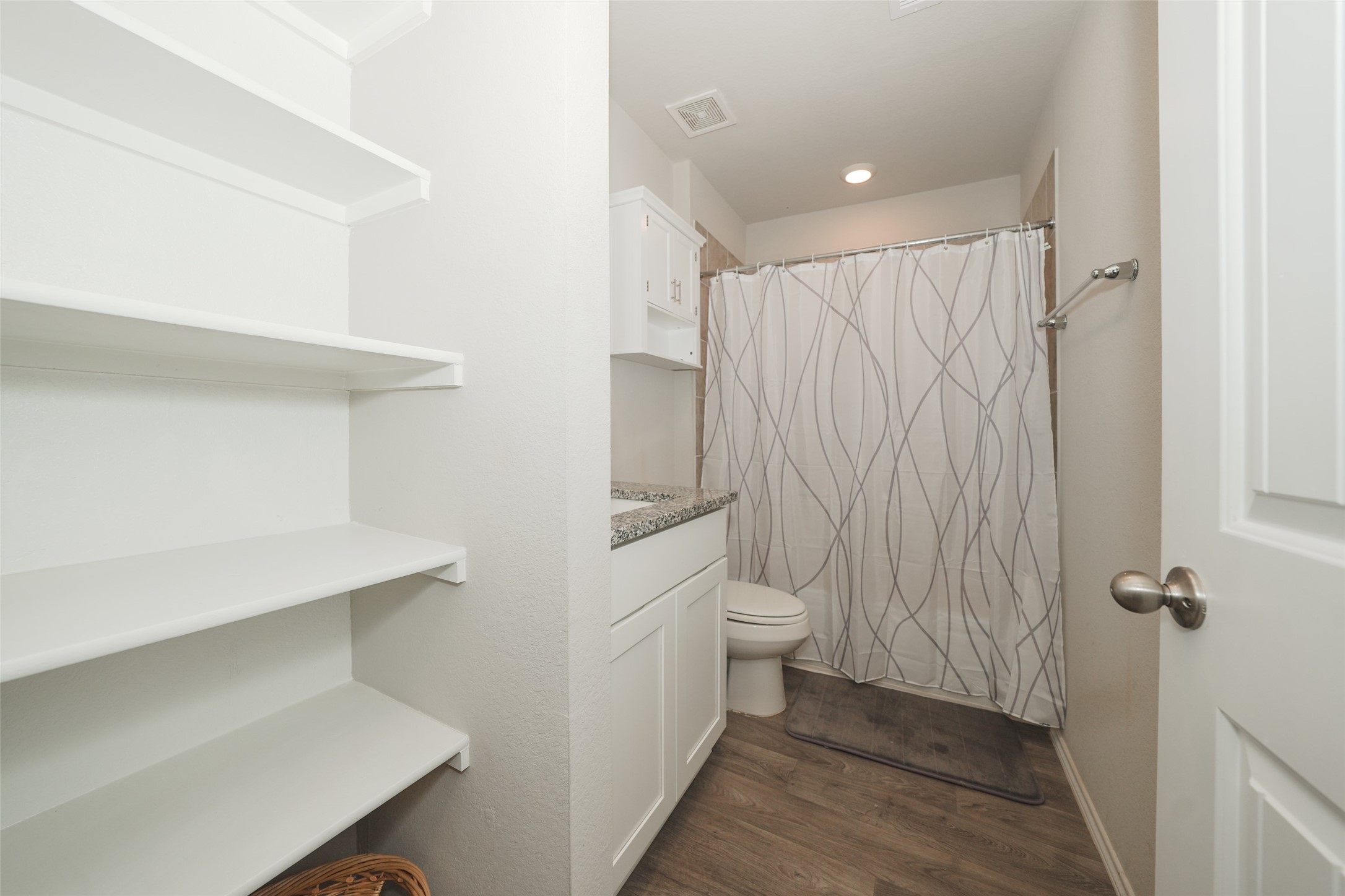 2407 Divot Lane Navasota, TX 77868 - Photo 5 of 37 a bathroom with a sink a toilet and shower