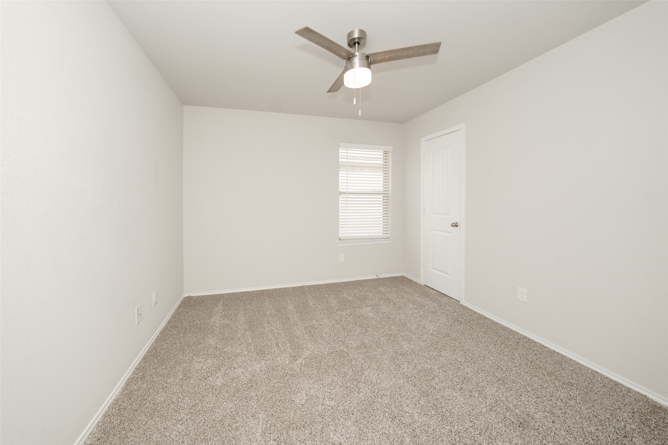 2407 Divot Lane Navasota, TX 77868 - Photo 7 of 37 an empty room with a window and a fan