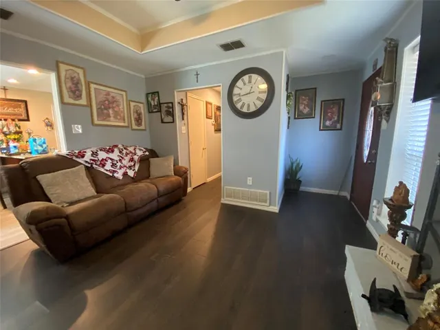a living room with furniture and a clock