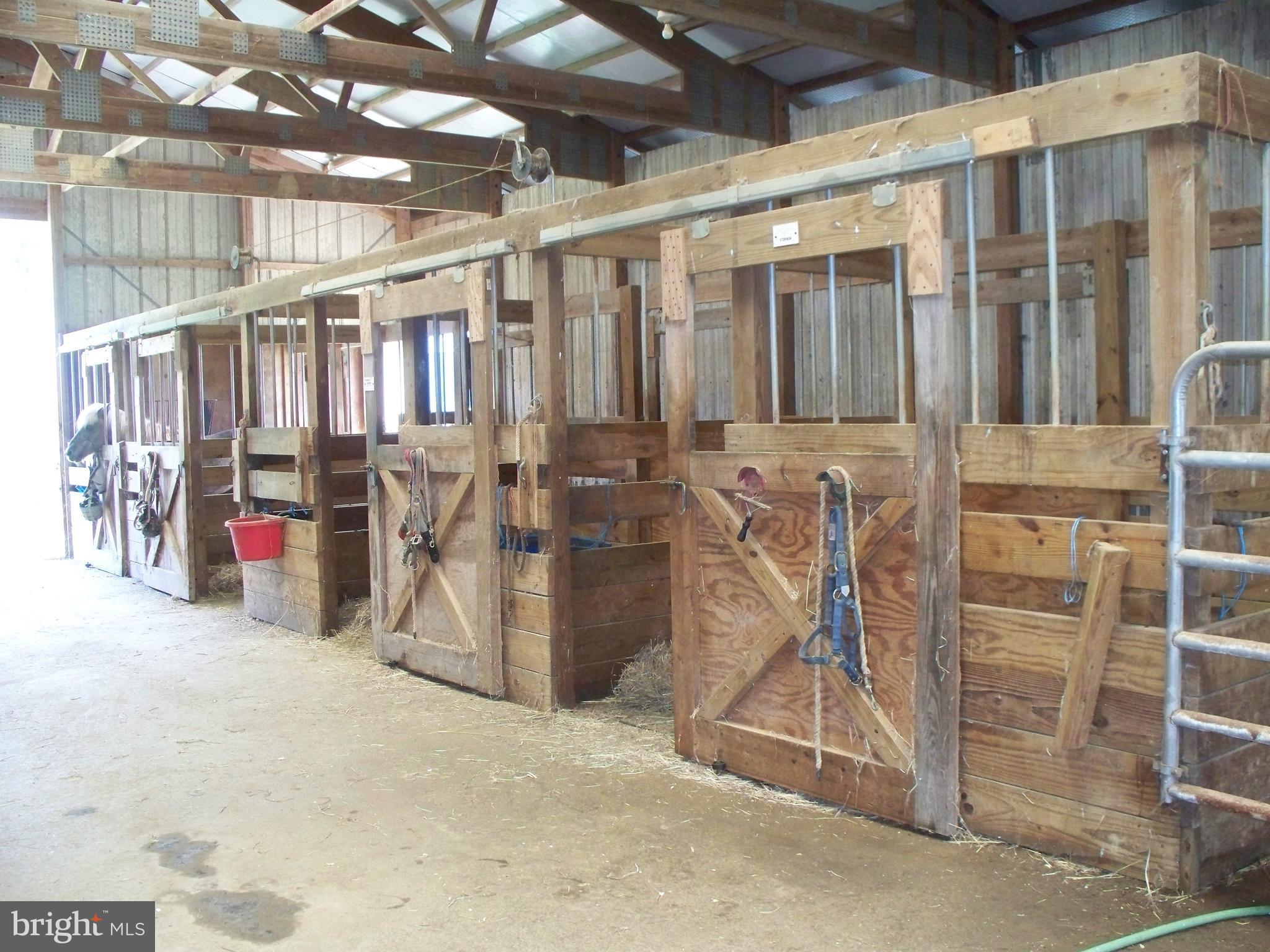 4825 Clermont Mill Road Pylesville, MD 21132 - Photo 24 of 30 Inside of 10-Stall Center Isle Barn