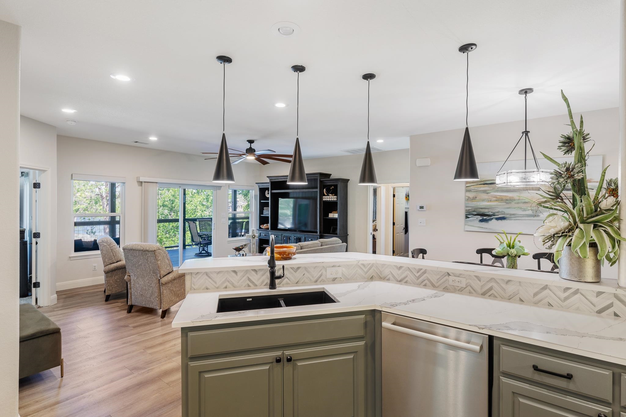 1633 Aztec Kingsland, TX 78639 - Photo 8 of 30 a kitchen with stainless steel appliances kitchen island granite countertop a sink a stove and a wooden floor