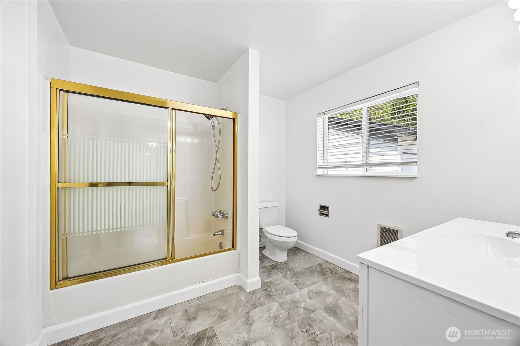 13710 Madrona Road Southwest Port Orchard, WA 98367 - Photo 23 of 40 a bathroom with a granite countertop sink toilet and shower
