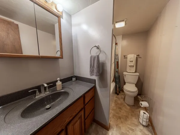 an empty room with wooden floor and door