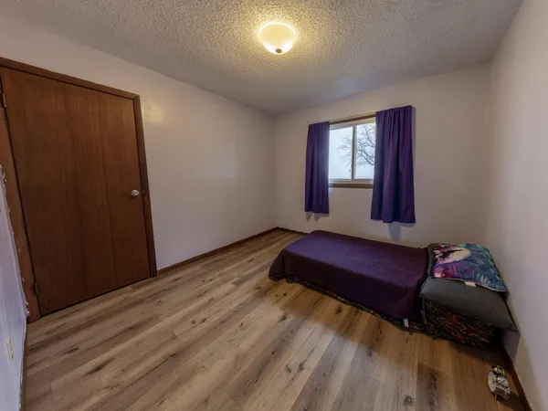 an empty room with windows and ceiling fan view