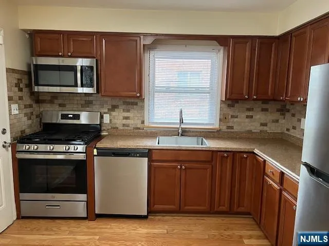 a kitchen with a sink stove and microwave