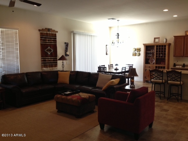 17902 West Verdin Road Goodyear, AZ 85338 - Photo 3 of 10 a living room with furniture and a chandelier