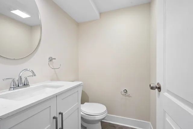 a bathroom with a toilet a sink a shower and vanity