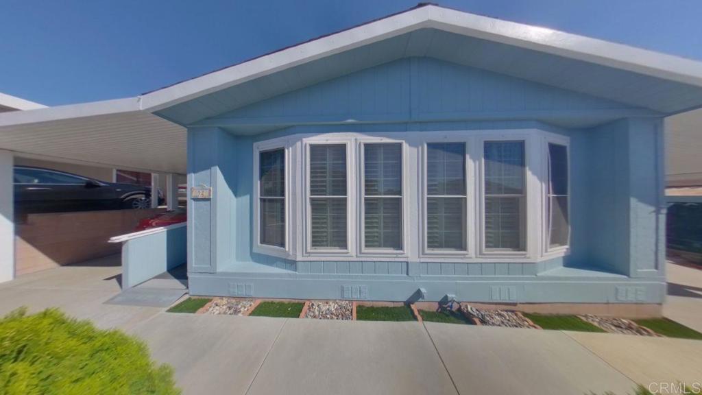 909 Richland Road, Unit 52 San Marcos, CA 92069 - Photo 2 of 28 a front view of a house with a yard