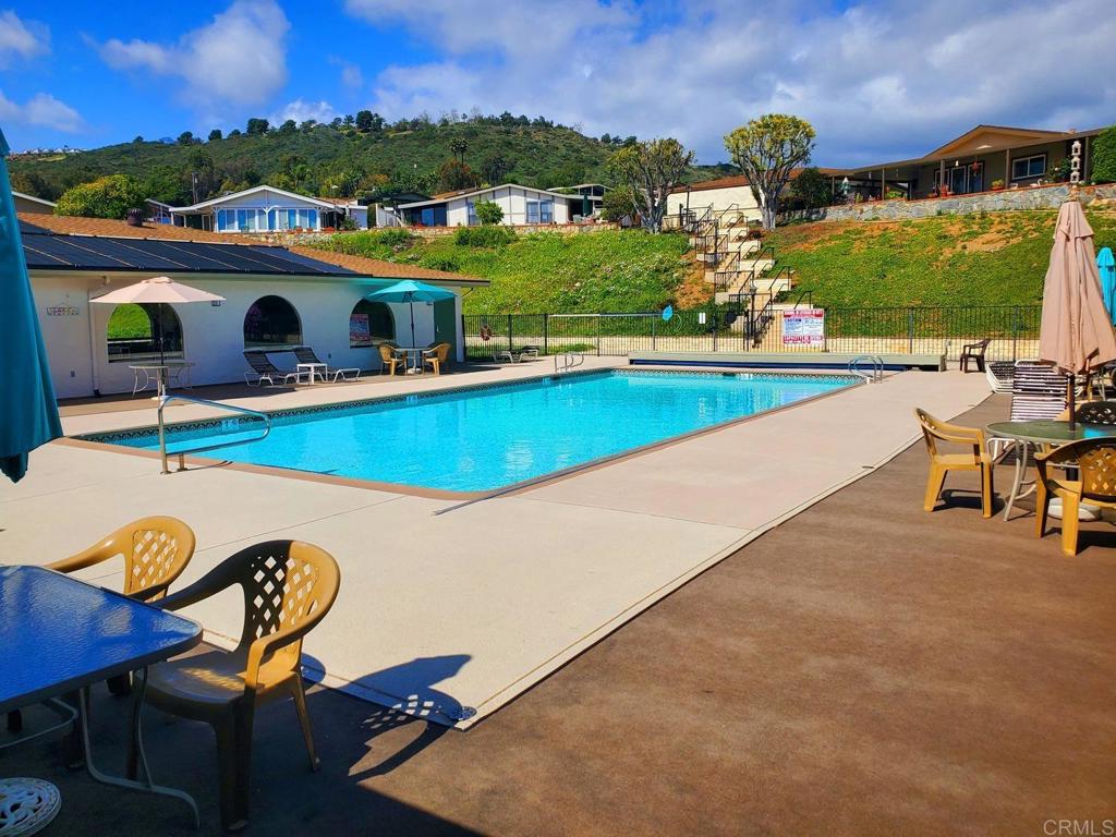 909 Richland Road, Unit 52 San Marcos, CA 92069 - Photo 25 of 28 a view of a swimming pool with a patio and a garden