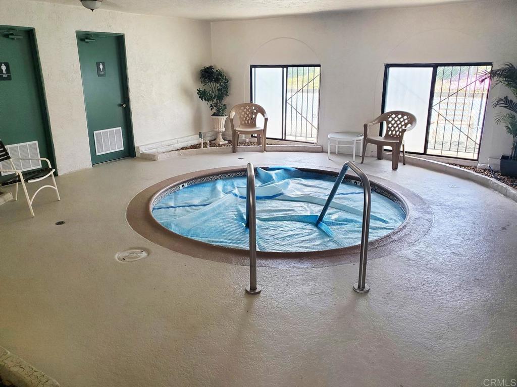909 Richland Road, Unit 52 San Marcos, CA 92069 - Photo 27 of 28 a living room with table chairs and a table