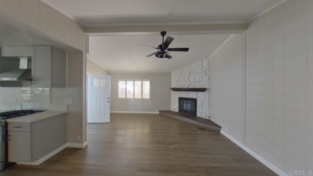 909 Richland Road, Unit 52 San Marcos, CA 92069 - Photo 4 of 28 a view of an empty room with a fireplace and a window