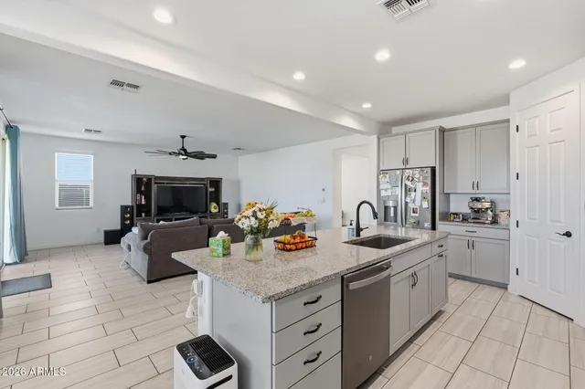 a kitchen with sink refrigerator and cabinets