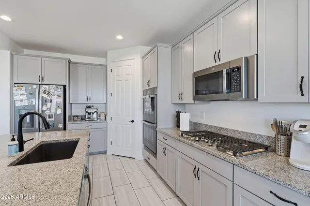 a kitchen with a sink stove and microwave