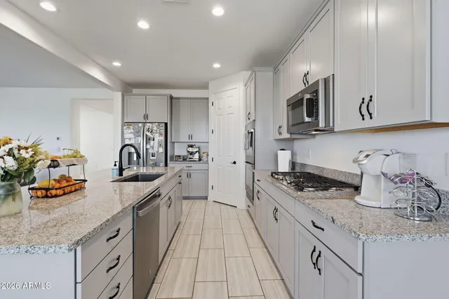 a kitchen with stainless steel appliances granite countertop a sink stove and cabinets