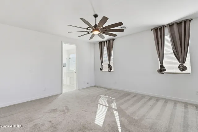 a view of a livingroom with a ceiling fan and wooden floor