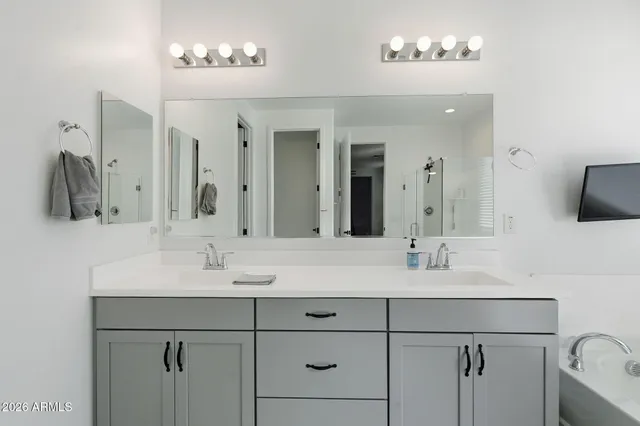 a bathroom with a double vanity sink and a mirror