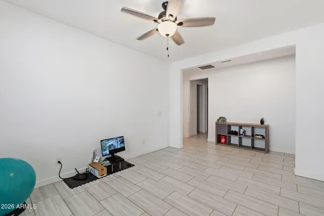 a bedroom with bed and a chandelier