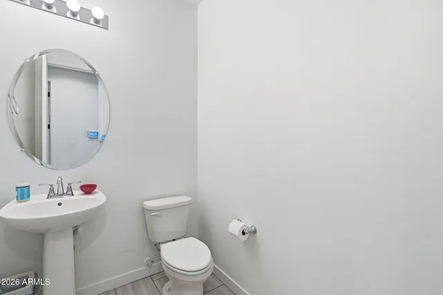a white toilet sitting next to a bathroom sink