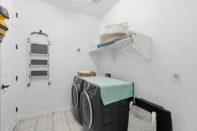a utility room with cabinets and washer