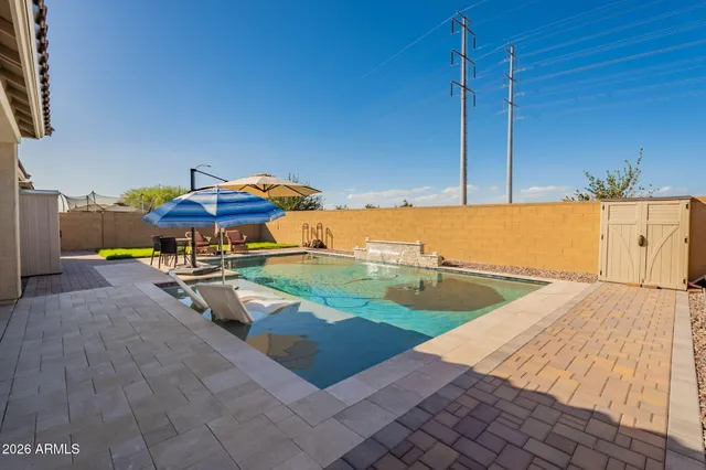 a view of a swimming pool with a lounge chair