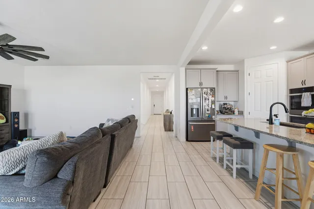 a large bedroom with a bed and a view of kitchen