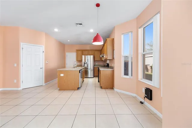 a kitchen with stainless steel appliances granite countertop a sink a stove and a refrigerator