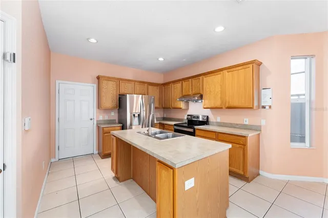 a kitchen with a sink a stove and refrigerator
