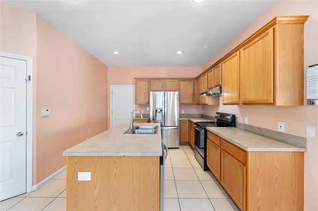 a kitchen with a sink stove and refrigerator