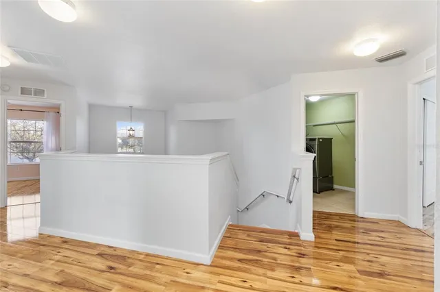 a view of empty room with wooden floor