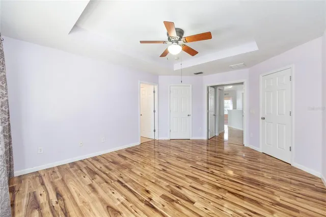a view of a bathroom with wooden floor and mirror