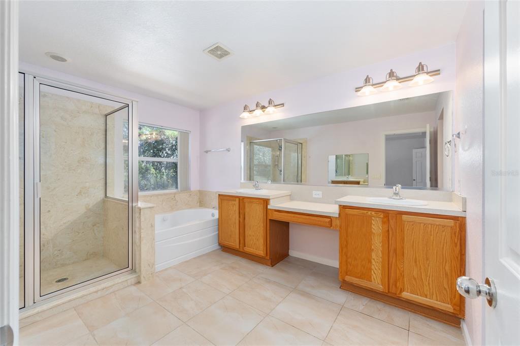 5073 Southwest 40th Place Ocala, FL 34474 - Photo 35 of 53 a bathroom with a tub sink and mirror